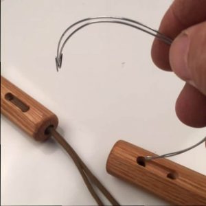 Insert rounded end of tool into other nunchaku.